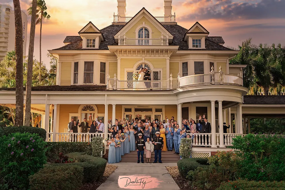 Doodle FLy Photography wedding photo of Group photo of wedding party and guests in the front of home at Burroughs Home Venue in Fort Myers Florida