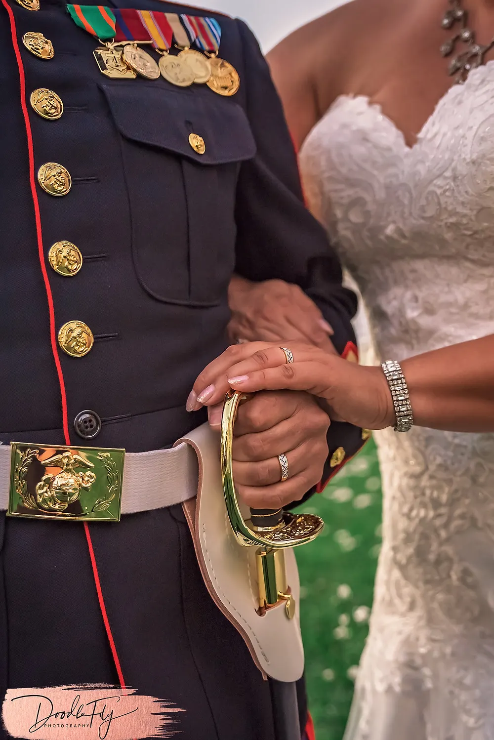Doodle FLy Photography wedding photo of bride and groom with Navy Uniform and gown with wedding rings  at Burroughs Home Venue in Fort Myers Florida